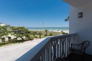 a balcony with a chair and a view of the ocean at Caribbean Resort Myrtle Beach in Myrtle Beach