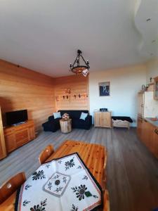 a living room with a table and a couch at Apartamenty na Szlaku in Czarny Dunajec