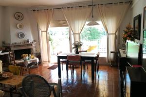 a dining room with a table and chairs in a room at Calella Playa in Calella +16 photos
