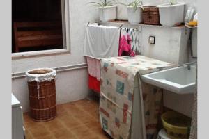 a bathroom with a box and a sink and a window at Calella Playa in Calella