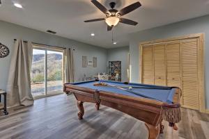 a pool table in a room with a ceiling fan at Hilltop Cabin on 5 Acres with Hot Tub and Waterfall! in Bryson City
