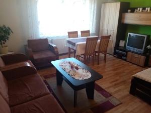 a living room with a table and a dining room at Domek in Reľov