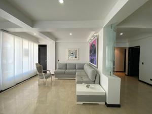 uma sala de estar com um sofá e uma mesa em Apartamentos Martinez em San Andrés