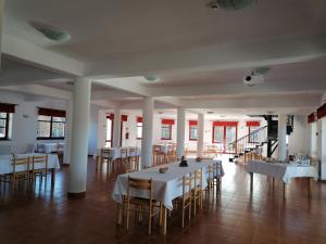 a large room with a table and chairs in it at Erzsébet Szálló in Izvoare