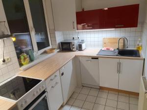 a kitchen with white cabinets and a wooden counter top at Studio NICO Dominsel in Brandenburg an der Havel