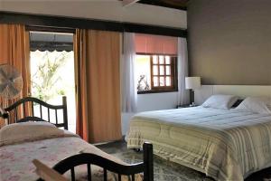 a bedroom with two beds and a window at Espaço Vila Lara in São Roque +68 photos