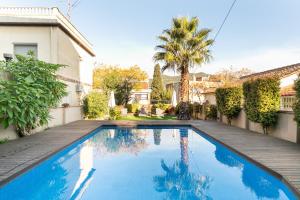 a swimming pool in the backyard of a house at TOWANDA HOUSE in Sant Just Desvern