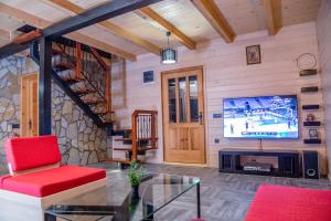 a living room with a large screen tv in a house at Vikendica Martinovic in Zlatibor
