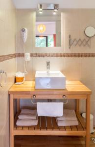 a bathroom with a sink and a mirror at La Maison Suites & Gastronomía in La Paloma