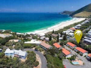 a hot air balloon flying over a beach at Blueys Beach Villa Manyana 24 in Blueys Beach