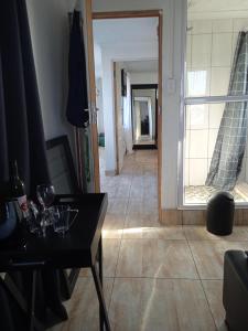 a living room with a table and a view of a hallway at ILITHA PARK in Cape Town