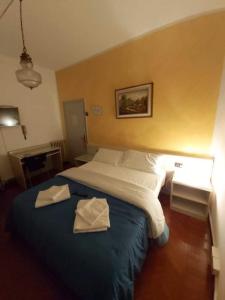 Postel nebo postele na pokoji v ubytování Hotel Arcella