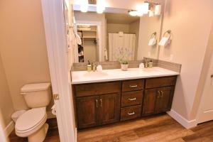 a bathroom with a sink and a toilet and a mirror at 103 Broken Pine by Casago McCall - Donerightmanagement in McCall