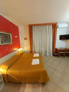 Postel nebo postele na pokoji v ubytování Hotel Arcella