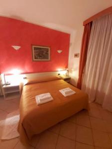 Postel nebo postele na pokoji v ubytování Hotel Arcella