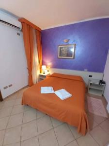 Postel nebo postele na pokoji v ubytování Hotel Arcella
