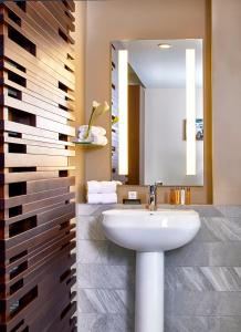 a bathroom with a sink and a mirror at Kimpton Overland Hotel - Atlanta Airport, an IHG Hotel in Atlanta