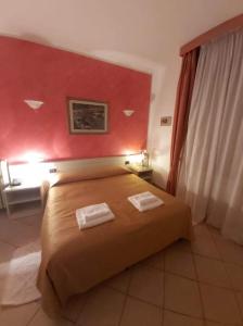 Postel nebo postele na pokoji v ubytování Hotel Arcella