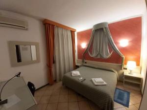 Postel nebo postele na pokoji v ubytování Hotel Arcella