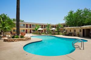 a swimming pool in front of a hotel at Travelodge by Wyndham Santa Maria in Santa Maria