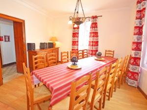 a dining room with a red and white table and chairs at Comfortable Villa in Tignes South of France near Ski Area in Tignes