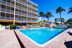 a swimming pool in front of a hotel at Windward Passage in Fort Myers Beach
