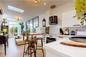 a kitchen with a table and chairs in a room at BANDOL Magnifique appartement en RDC cour sans vis à vis 5mn plage in Bandol