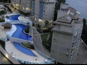 a building with a swimming pool next to a building at Porto Real Resort in Mangaratiba
