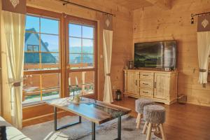 a living room with a tv and a table at Domy na Spiszu in Czarna Góra