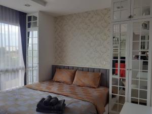 Ένα ή περισσότερα κρεβάτια σε δωμάτιο στο Cozy near beach 200m with toproof pool at Patio Bangsaen +23 φωτογραφίες