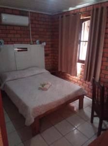 Cama o camas de una habitación en Alojamiento Termal Guaviyú