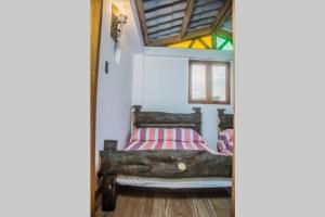 シルカシアにあるLos Tulios Alojamientoのベッドルーム1室(木製ベッド1台付)