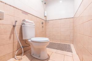 a bathroom with a toilet and a shower in it at The Kartini 8 Residence - Mangga Besar in Jakarta