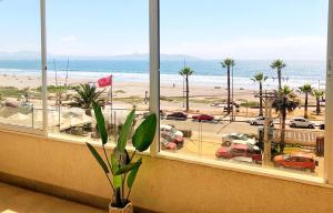 a window with a view of a beach and the ocean at Aqua La Serena in La Serena