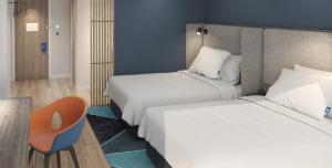Postel nebo postele na pokoji v ubytování Holiday Inn Express Shanghai Huijin by IHG