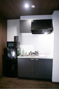 a kitchen with a sink and a stove at s-rea TOKYO 201 in Tokyo