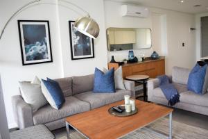 a living room with a couch and a table at Pebble Beach 304, Sibaya in Sibaya