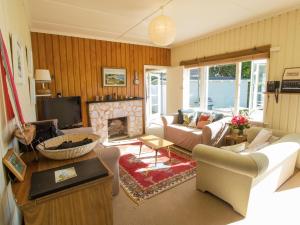 a living room with a couch and a fireplace at Incredible Bay Views - Kaiteriteri Bach in Kaiteriteri