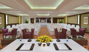 a banquet hall with white tables and chairs and flowers at Fortune Park, Haridwar - Member ITC Hotels' Group in Haridwār