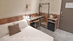 a hotel room with a bed and a sink at Morn forest apartment in Tainan