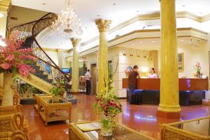 a lobby with a staircase and people in a building at The Spring Hotel in Ho Chi Minh City