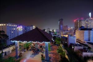 a gazebo in the middle of a city at night at The Spring Hotel in Ho Chi Minh City