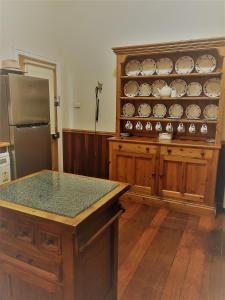 a kitchen with a refrigerator and a cabinet with dishes at York Cottages and Burnley House in York