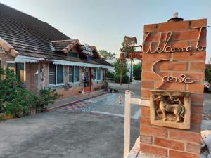 a building with a fireplace in front of it at Scenic Riverside Resort in Kamphaeng Phet