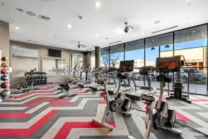 a gym with treadmills and ellipticals at Kasa Highland Park Dallas in Dallas