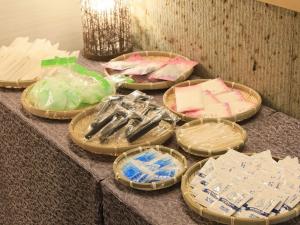 a table with several plates and utensils on it at Tamayura Hotel Asakusa in Tokyo