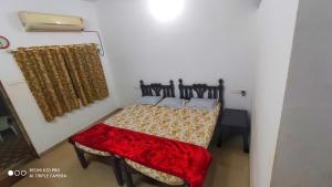 Uma cama ou camas num quarto em Chandraprabha Nyahari Niwas