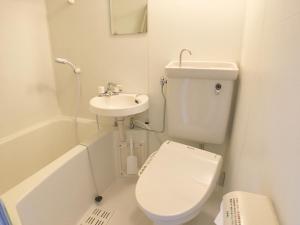 a white bathroom with a toilet and a sink at Coco Fukuoka Chiyo in Fukuoka +22 photos