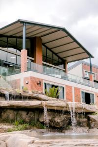 a building with a fountain in front of a building at Dragonview Lodge in Winterton