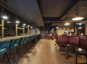 a bar with a row of chairs and a bar counter at Modern Inn in Taichung